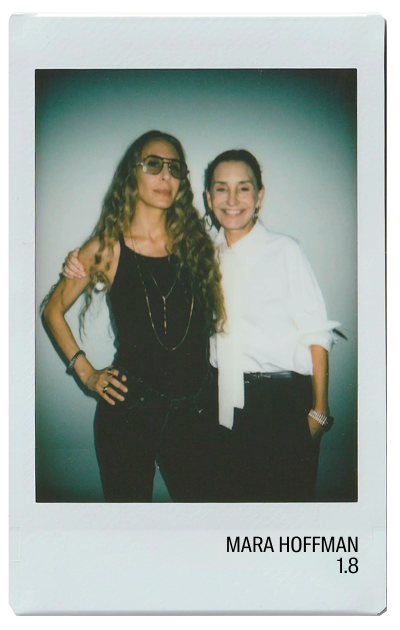 Two women posing together in a photo, one wearing glasses.