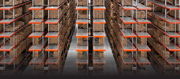 Rows of shelves filled with boxes in a warehouse setting.