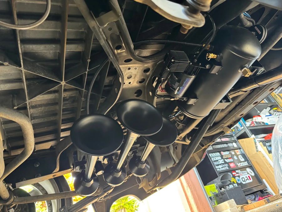 Undercarriage three black train horns air tank compressor crossmember workshop floor Jermyn's Tacoma Xrunner Flatlaw 127H gallery photo 2