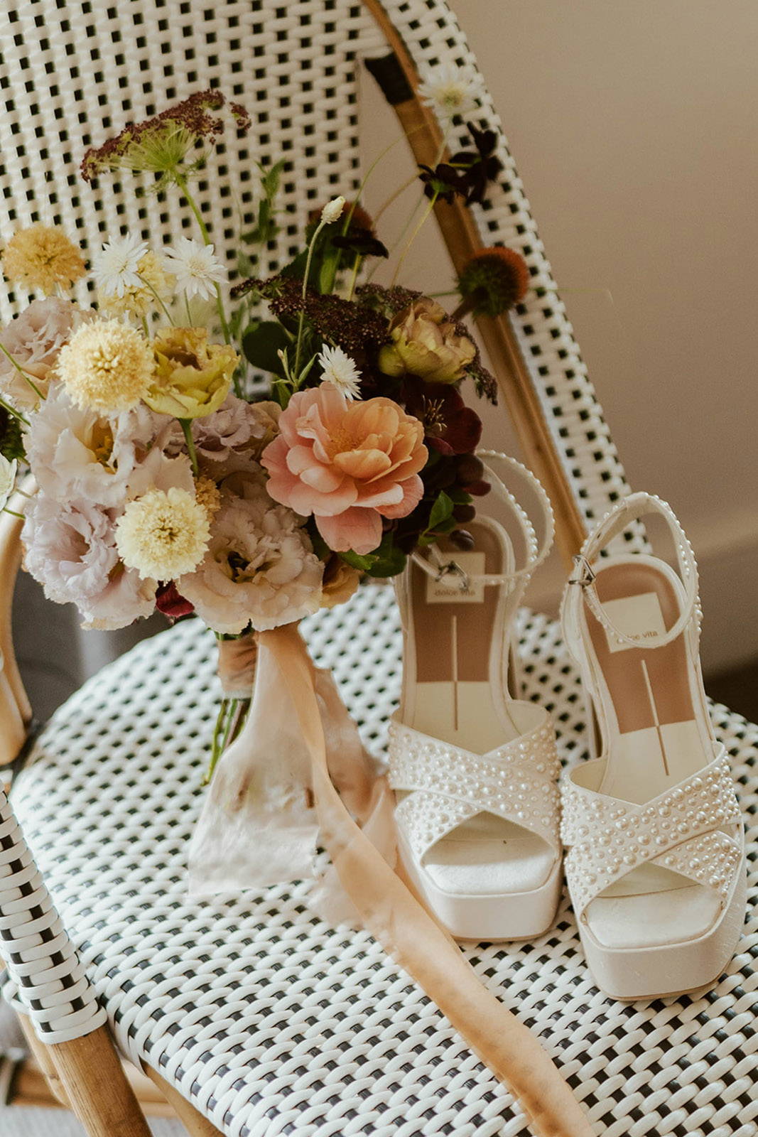 Bride's heels and floral bouquet.