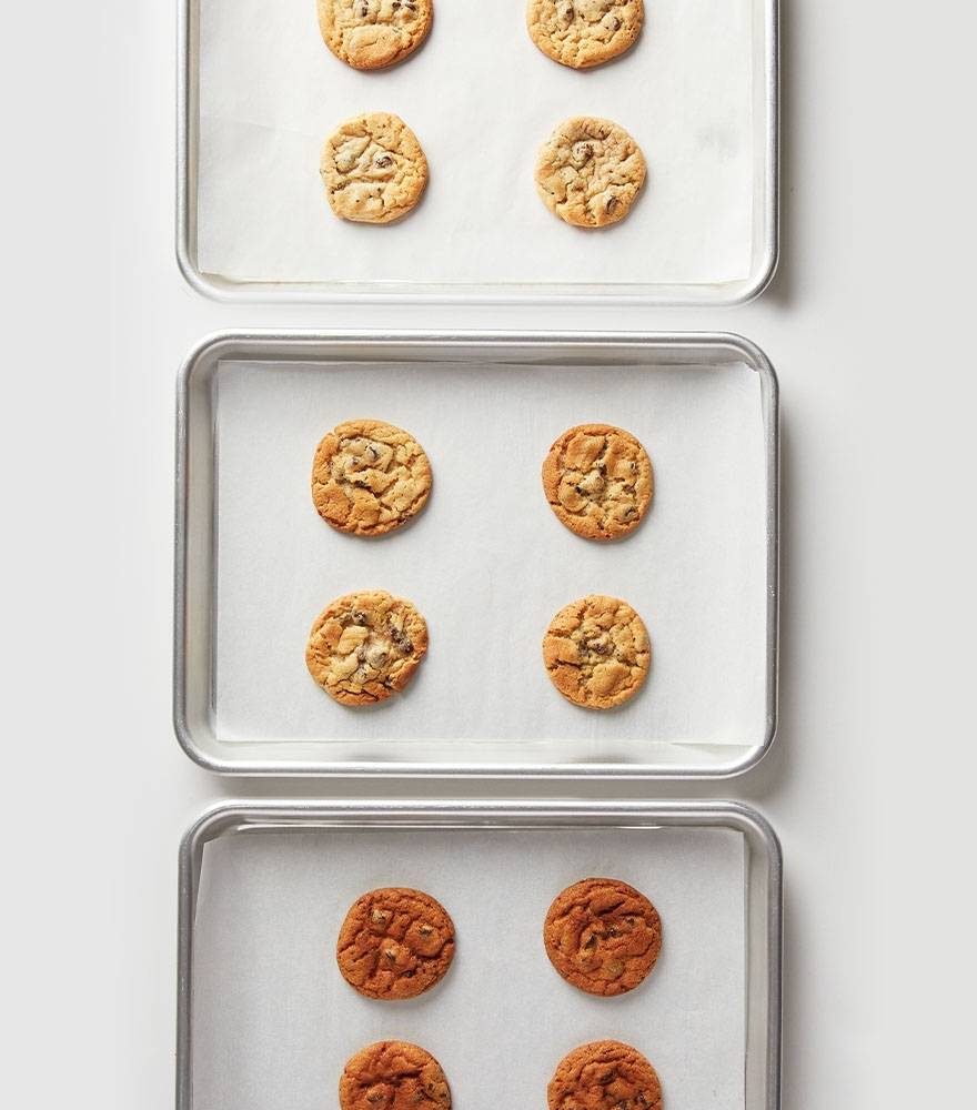 Three sets of cookies baked in the same conditions can turn out very differently — one is burnt, one is perfect, and the last is undercooked.