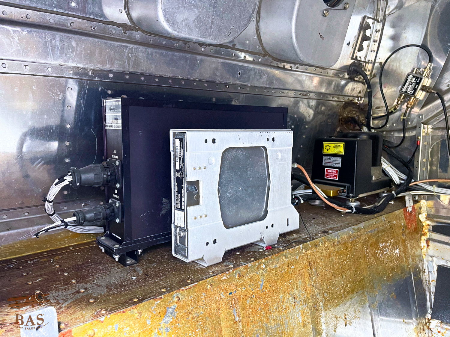 Electronic equipment mounted inside a metal casing with visible wires and components.