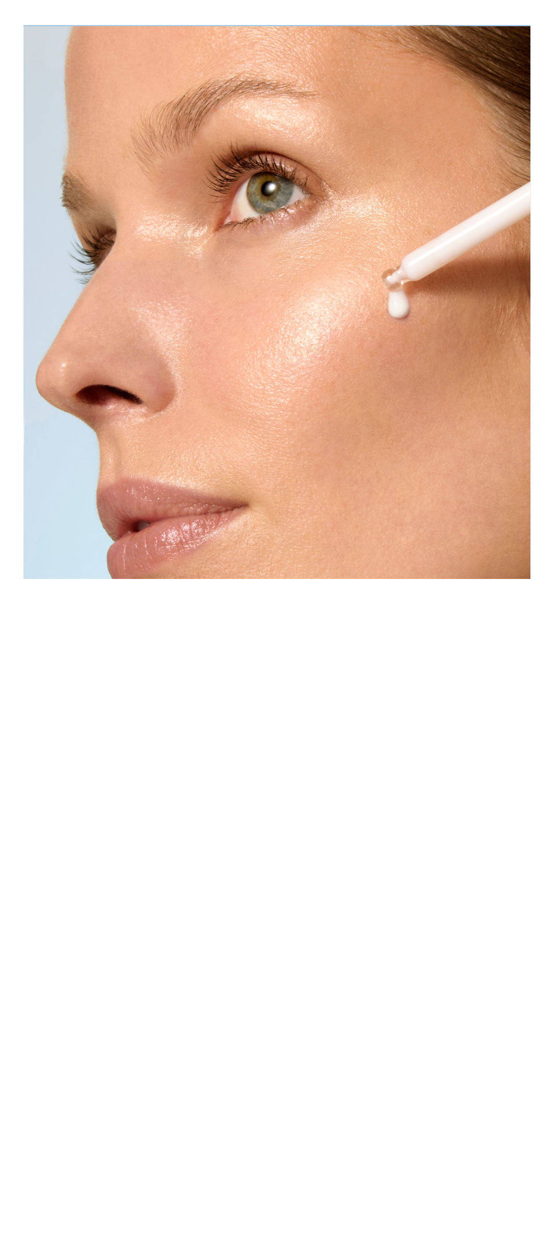 A woman applying skincare product under her eye.