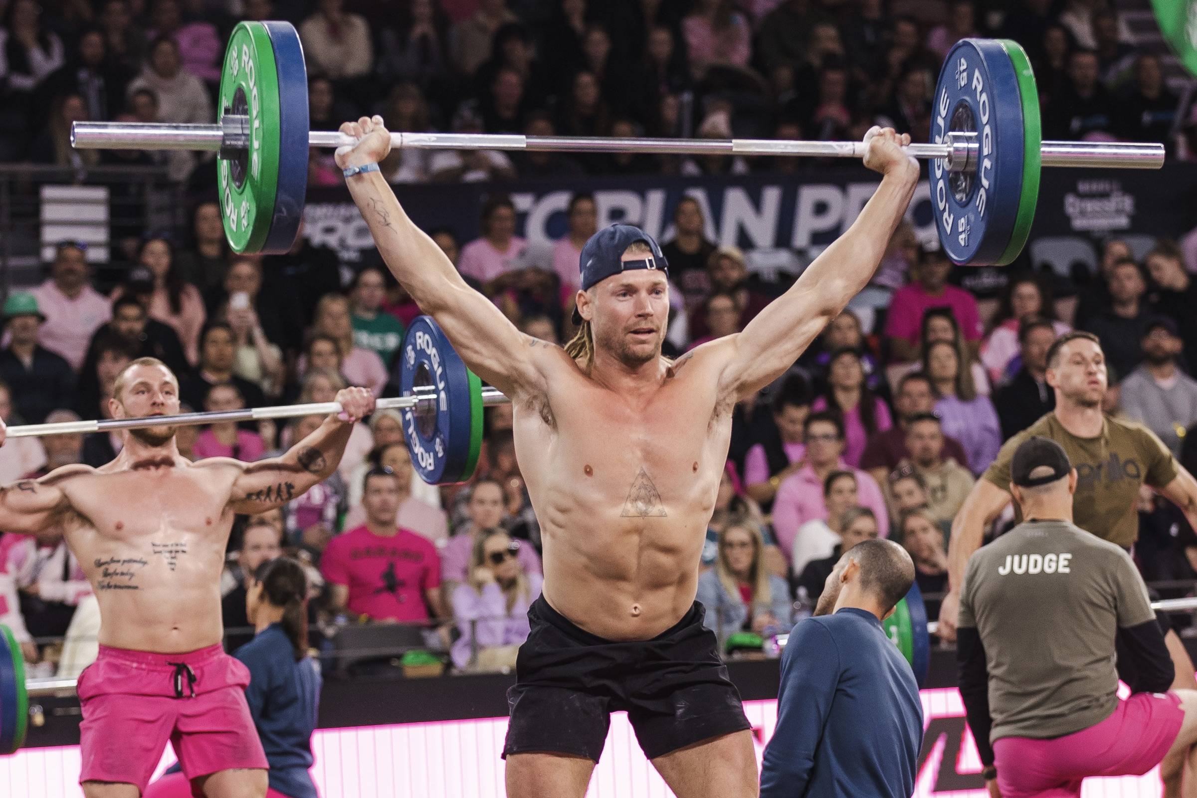 man lifting a barbell above his head