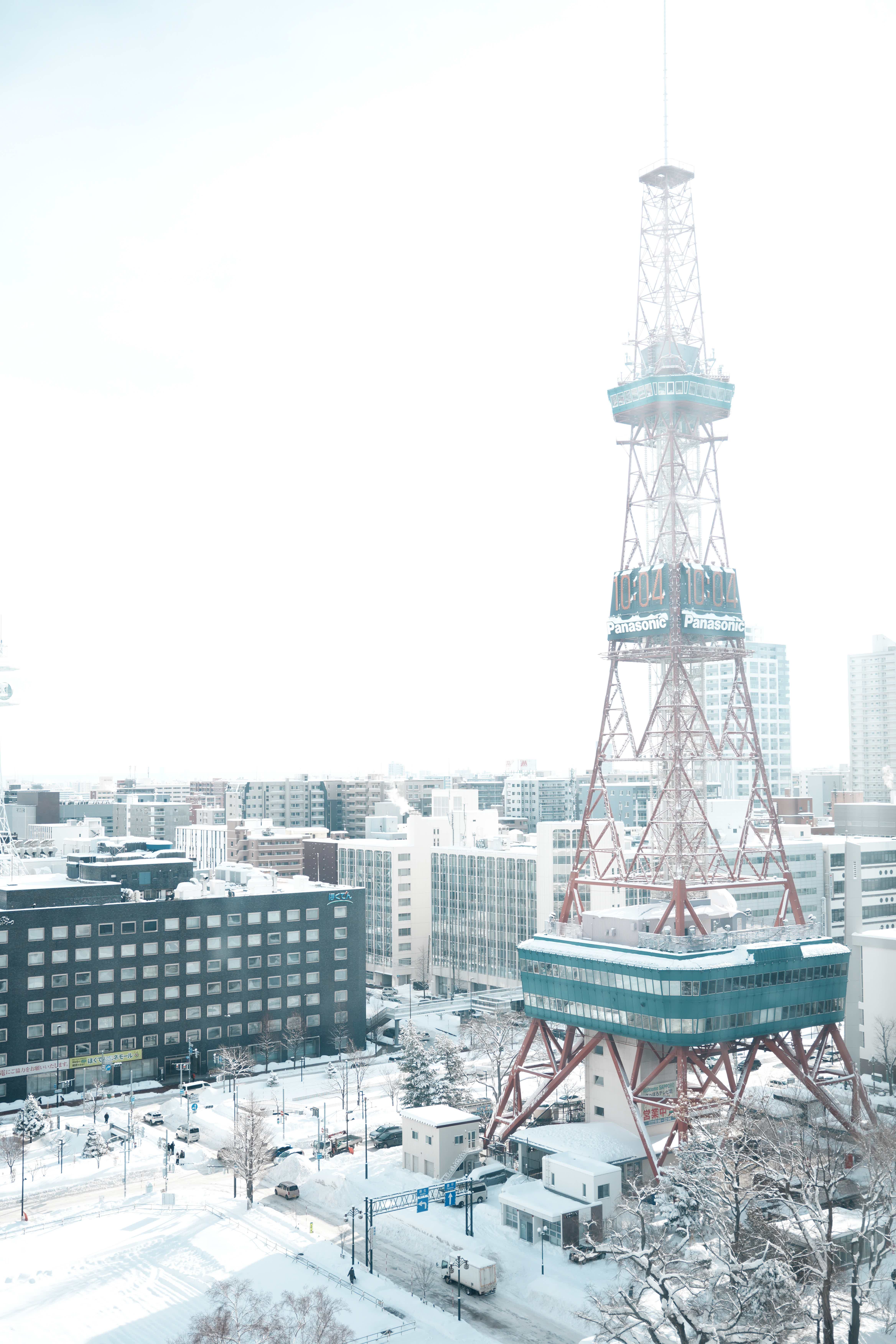 Sapporo TV Tower in winter with snow-covered surroundings.