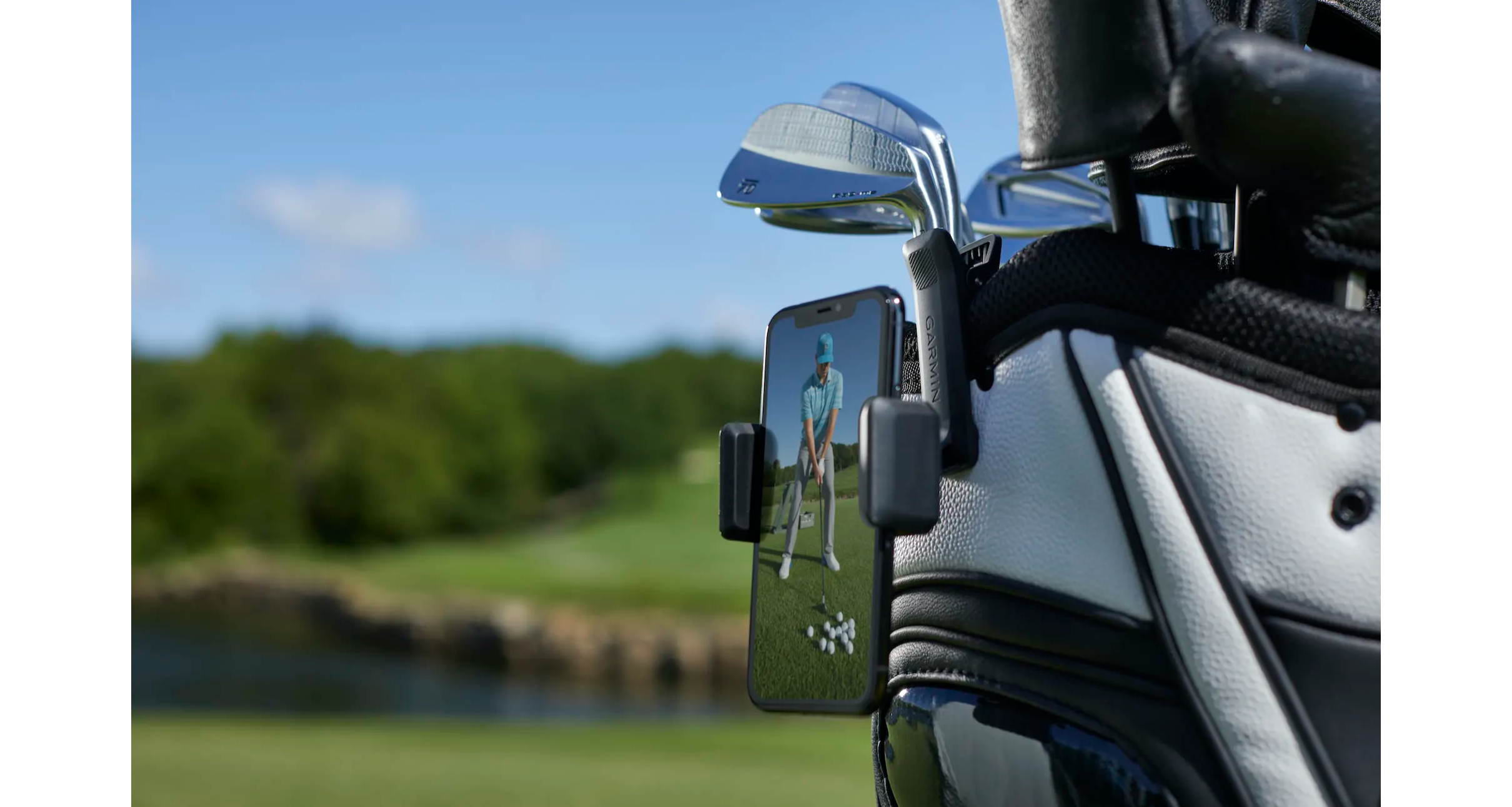 Golfer using the phone clip with the Garmin Approach R10 portable launch monitor