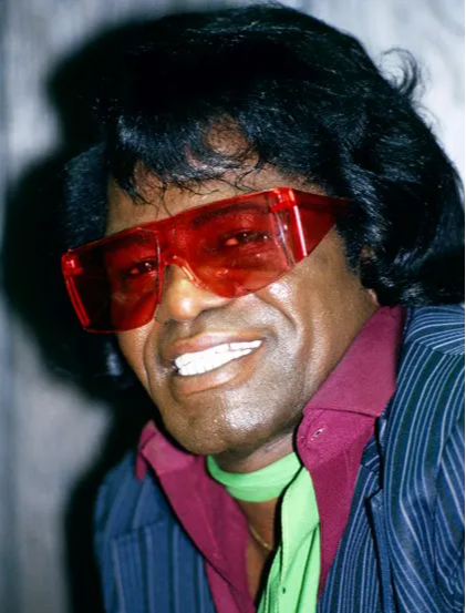 Singer James Brown wearing red funky sunglasses