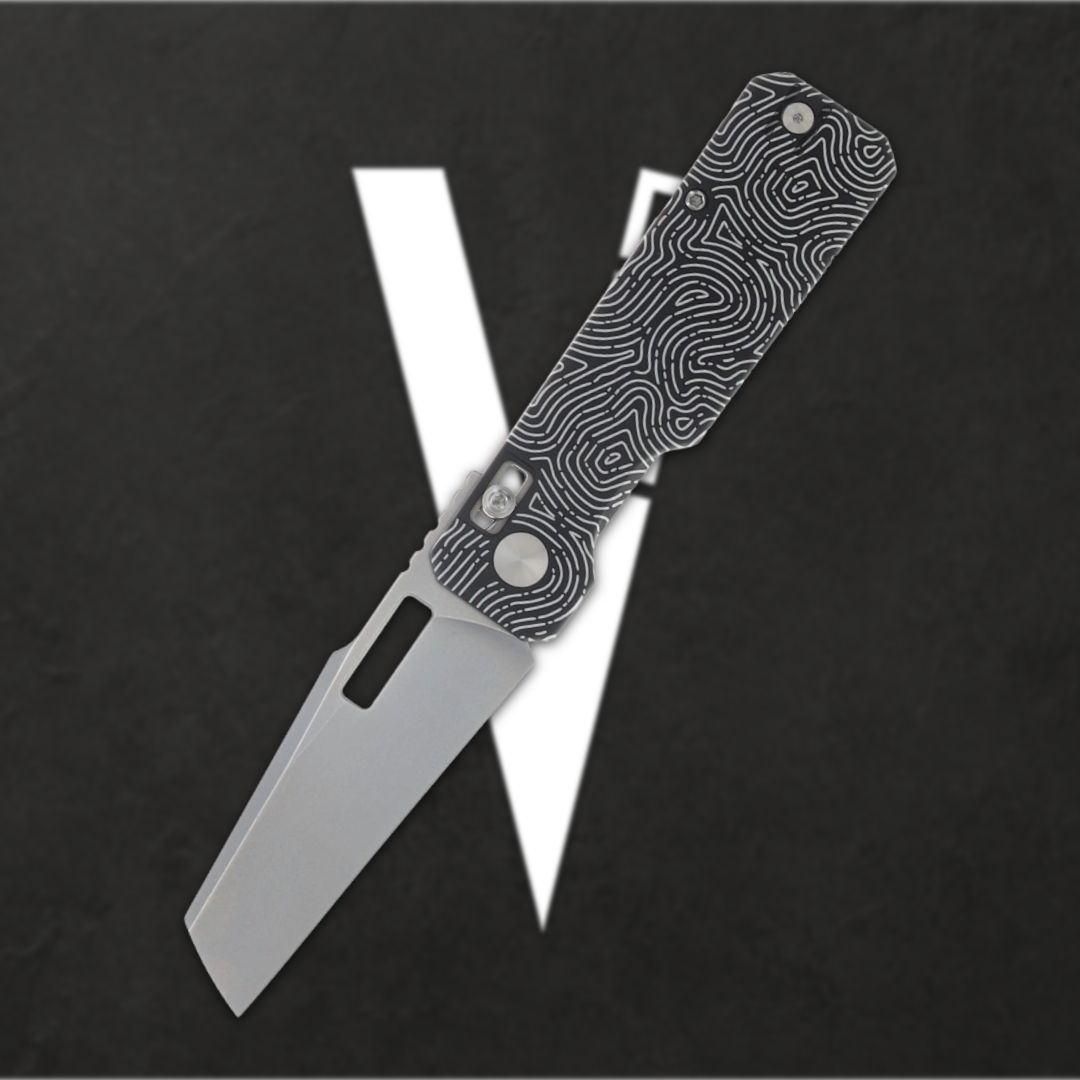 Folding knife with a textured handle against a black and white background.