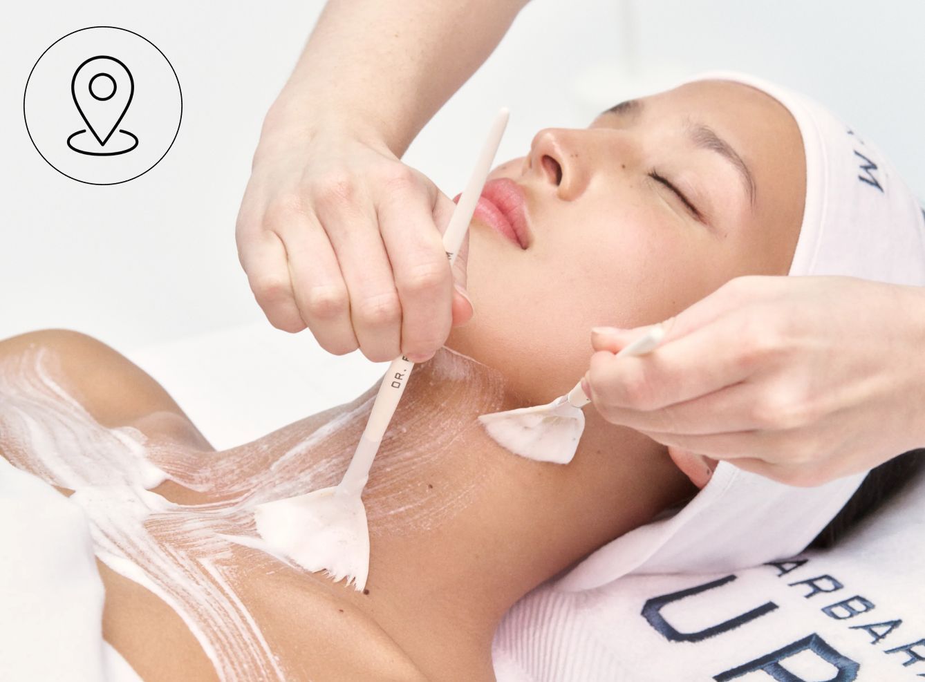 A person receiving a facial treatment with a mask being applied.