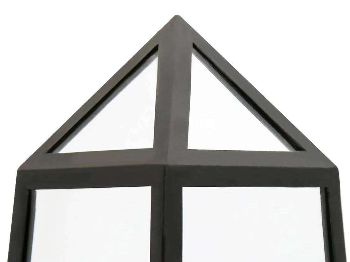 Black geometric structure with a triangular top and transparent panels.