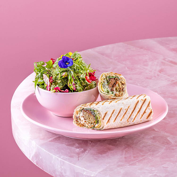 Falafel EL&N wrap with salad on pink background
