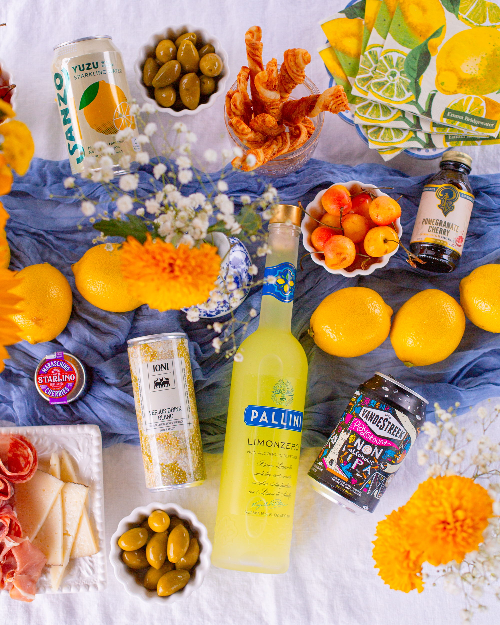 A flatlay tablescape of lemons and drinks