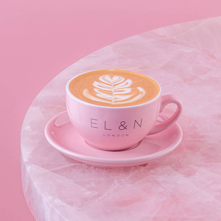 Cappuccino coffee on pink background