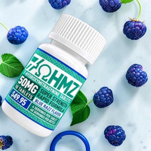 Bottle of supplements with raspberries and green leaves on a light background.