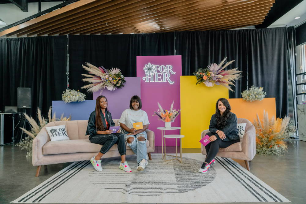 kamry james and two hosts at for her event