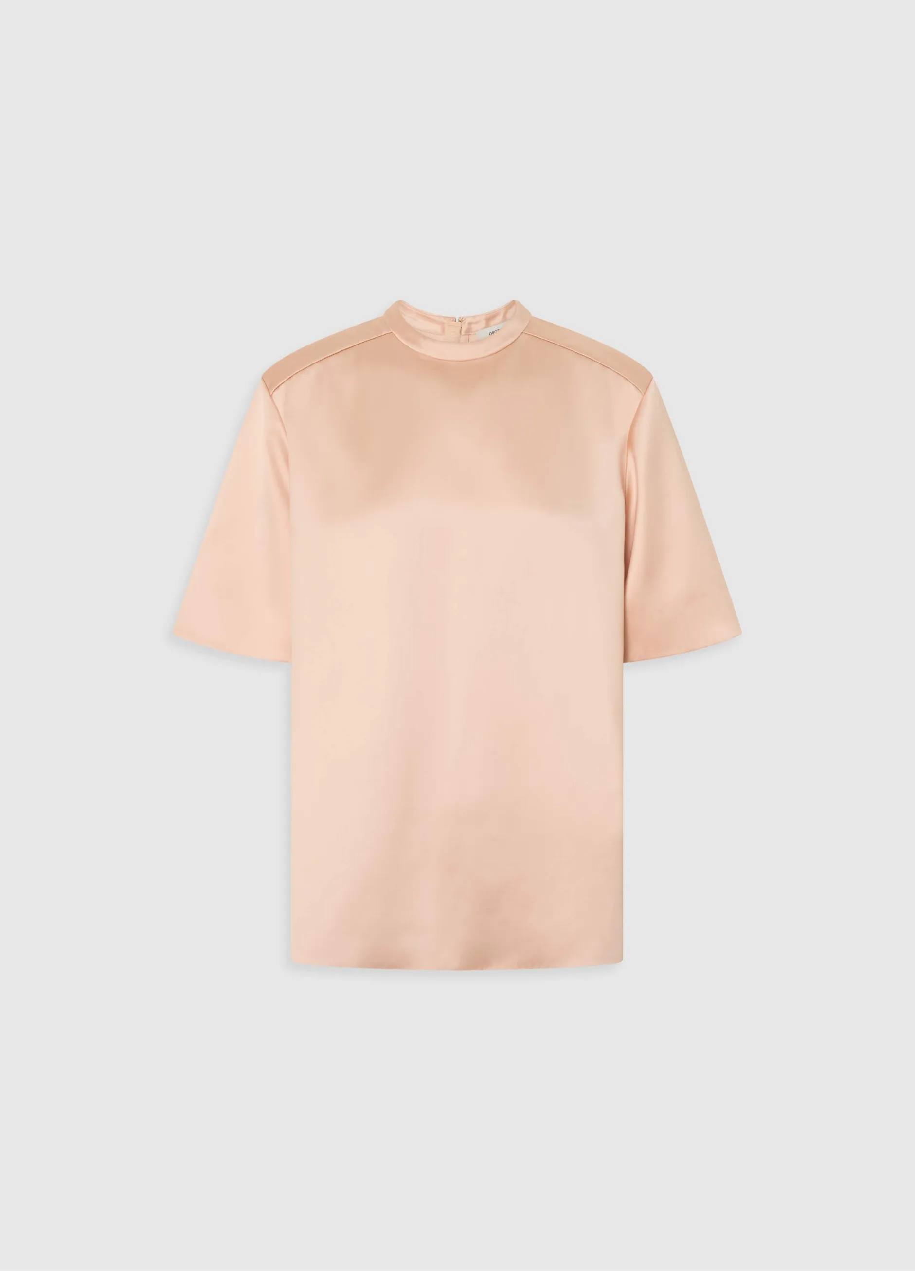 Short-sleeved, peach-colored top with a high neckline.