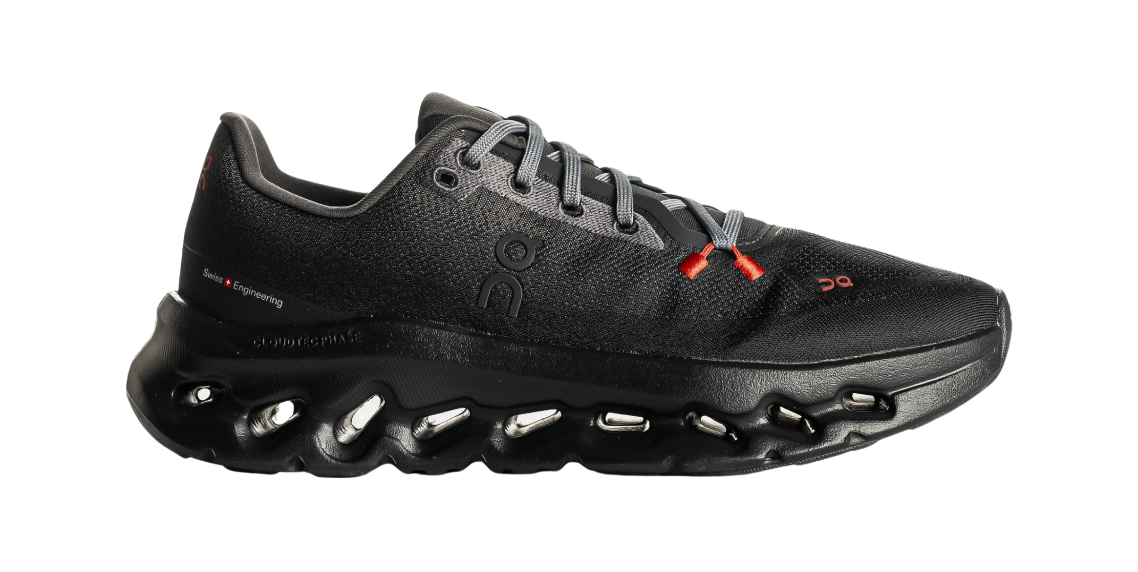 Black athletic shoe with red accents and unique sole design.
