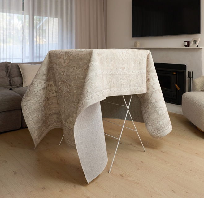 Table covered with a cloth, in a cozy living room setting.