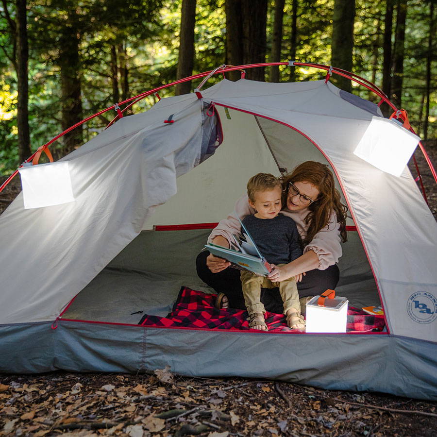 Mother and child's tent lit up by lanterns.