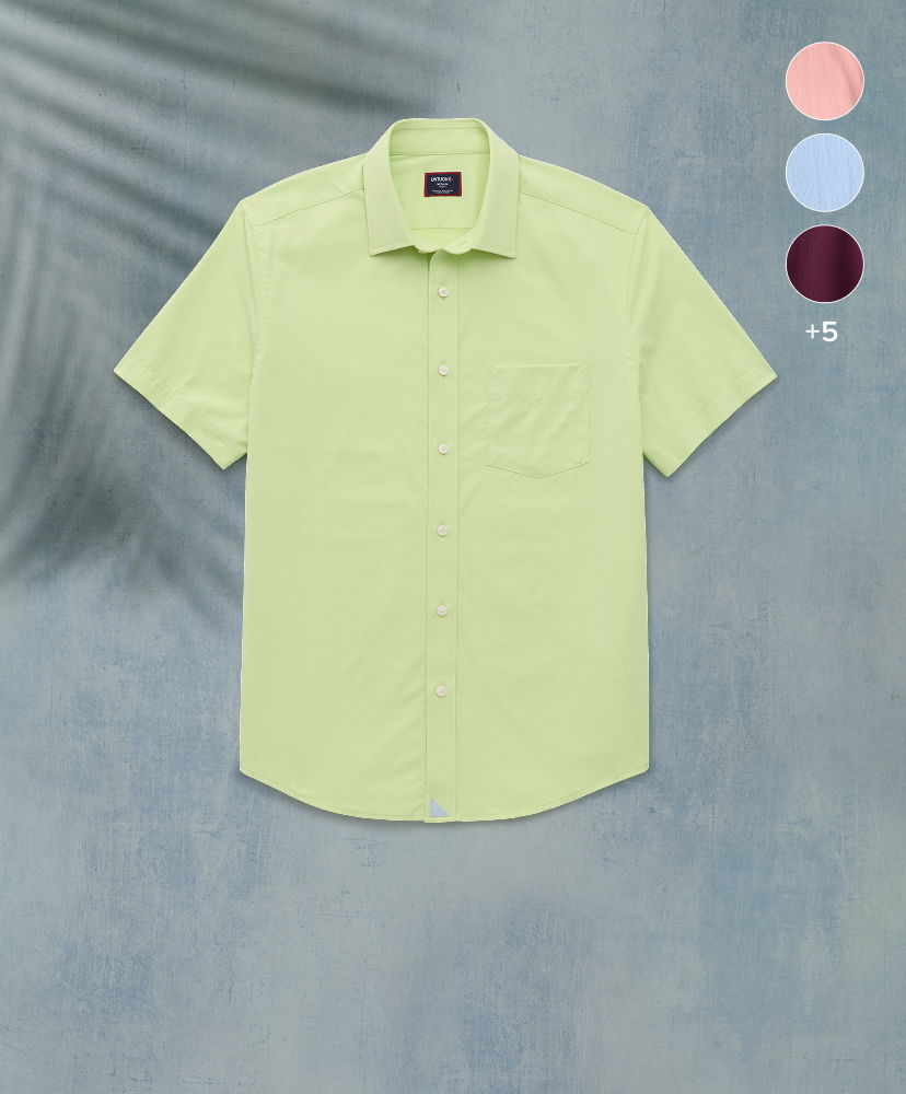 Light green short-sleeve shirt on a textured background with color options.