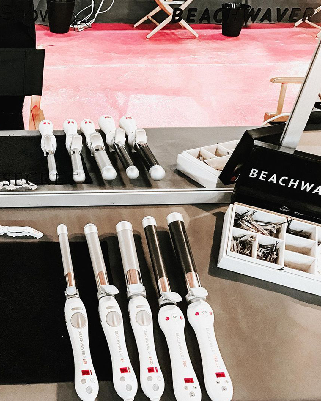 Image of Beachwaver tools lined up in a line backstage.