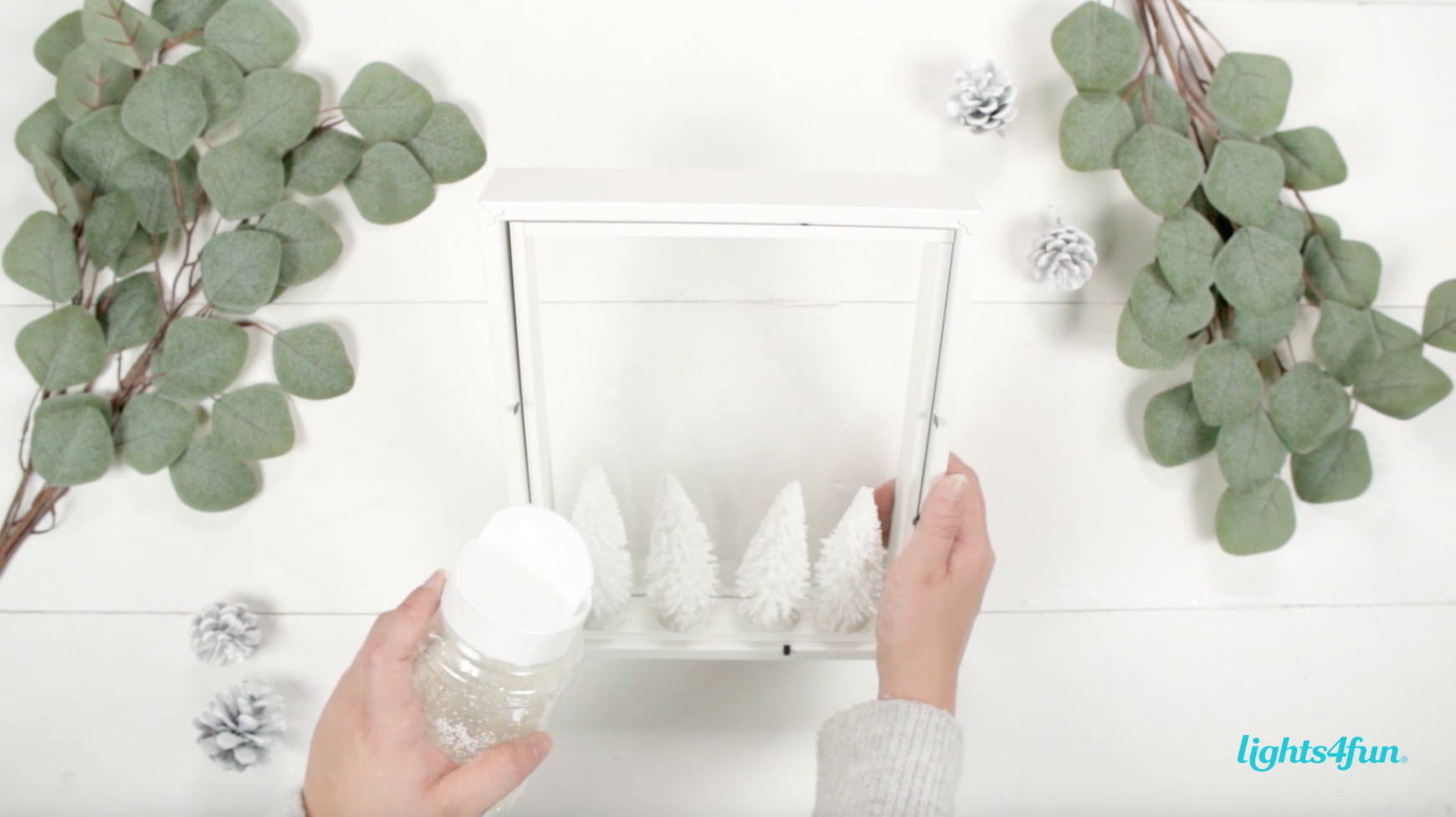 The first step in a Scandi inspired DIY.  Adding fake snow to the mini Christmas tree forest. 