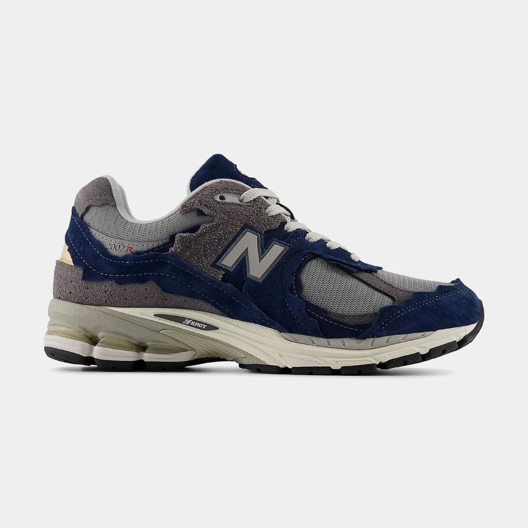 Blue and gray New Balance sneaker on a plain background.