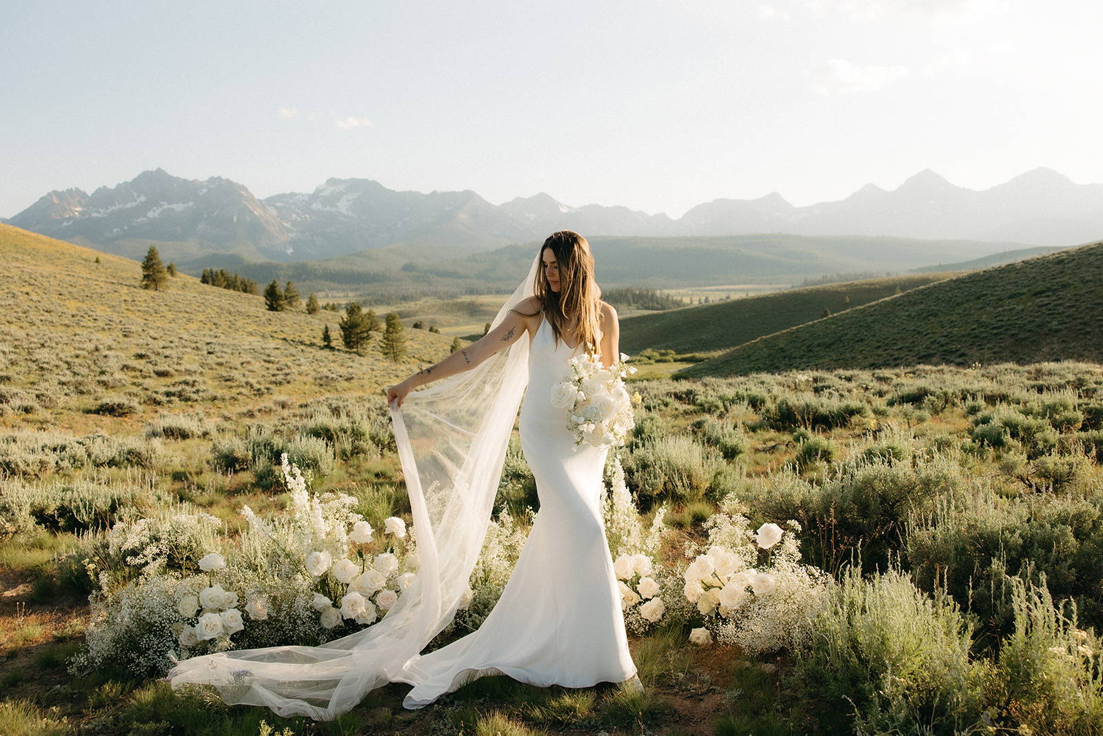 Bride in summer gown in the mountains