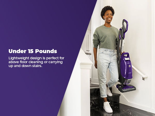 Woman holding a vacuum cleaner on stairs, promoting lightweight design under 15 pounds.