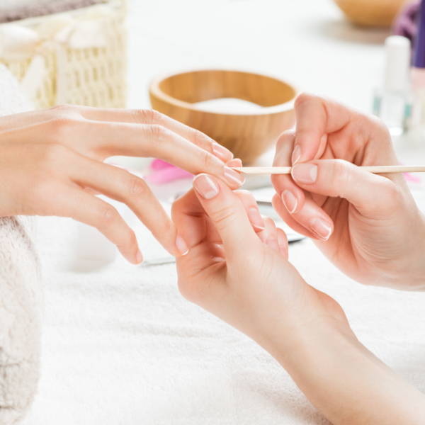 A professional manicure helping someone have healthy nails.