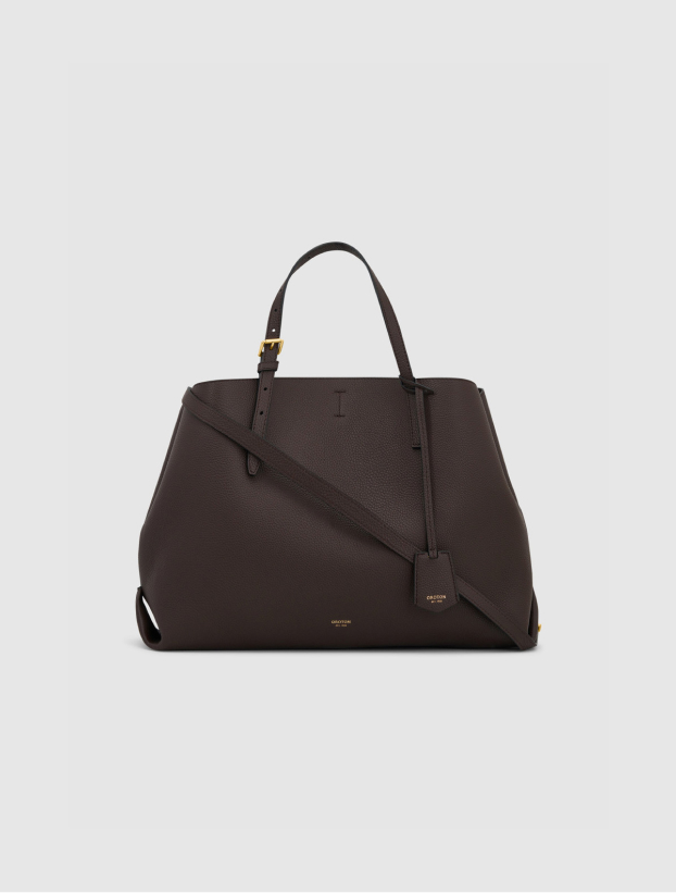 A dark brown handbag with two handles and a detachable strap.