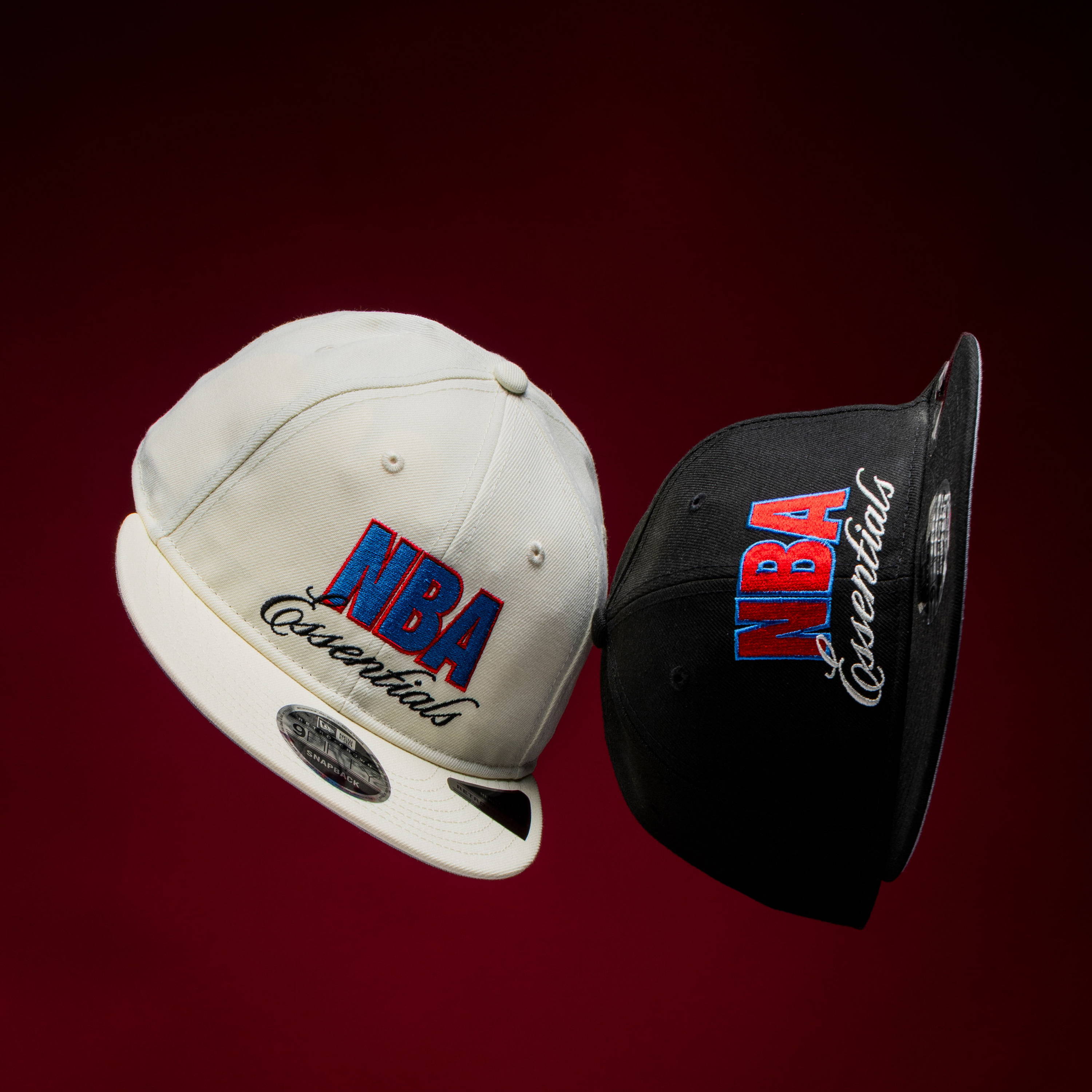 Two NBA championship caps on a dark background.