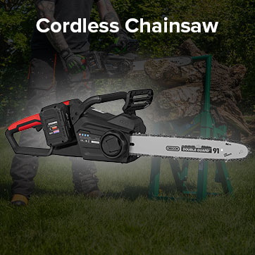 Cordless chainsaw displayed in a landscaped outdoor setting.