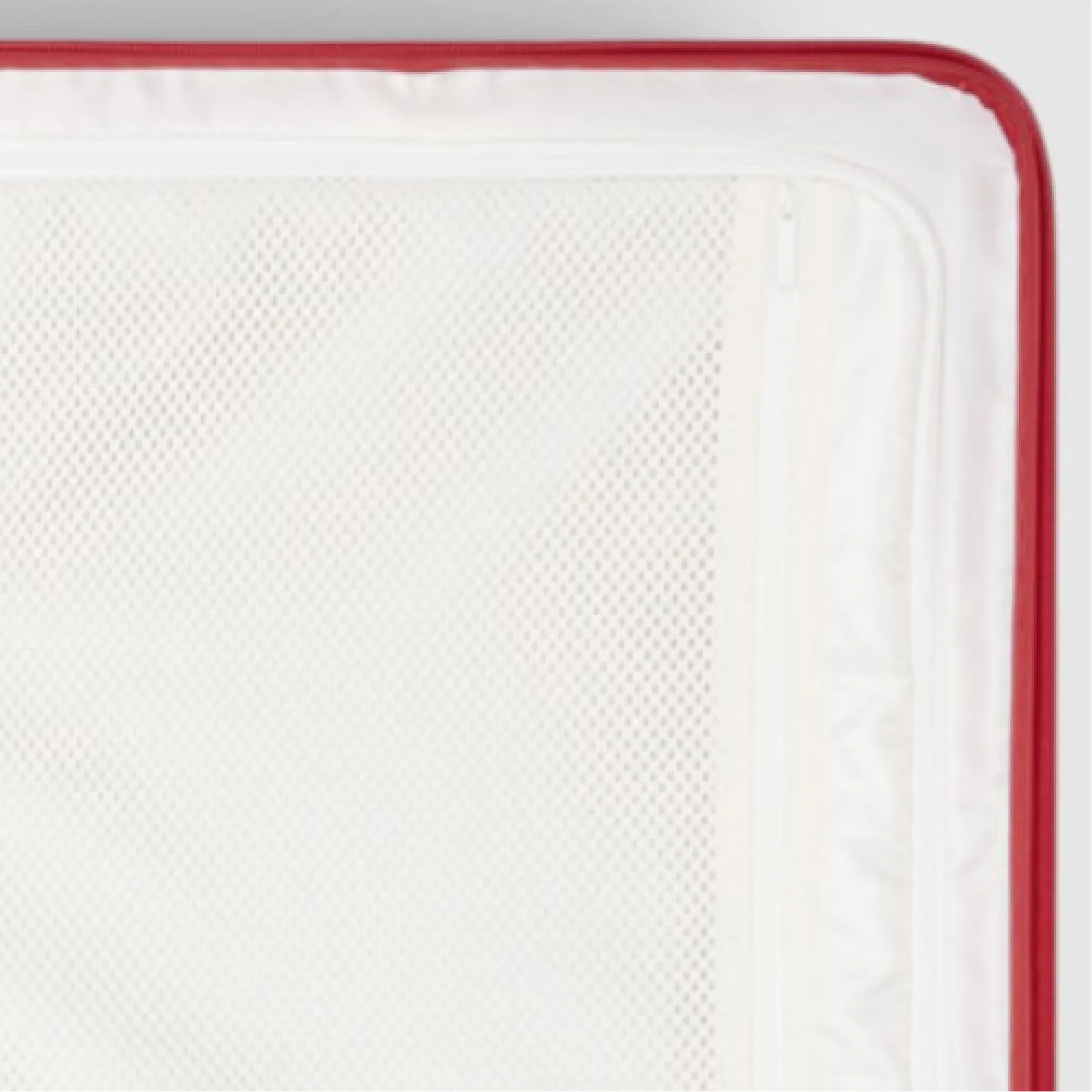Close-up of a white mattress with a red edge.