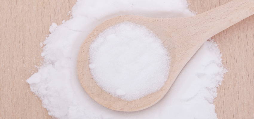 Image of a wooden spoon with MSM powder.