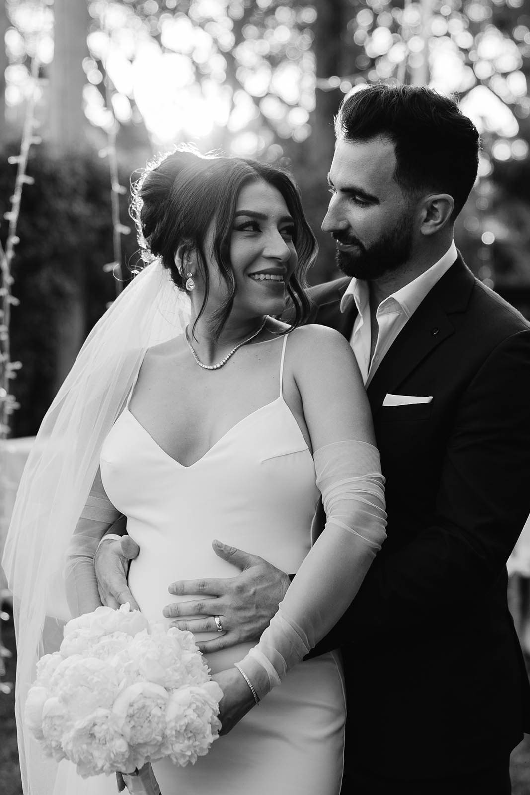 Groom holding pregnant bride