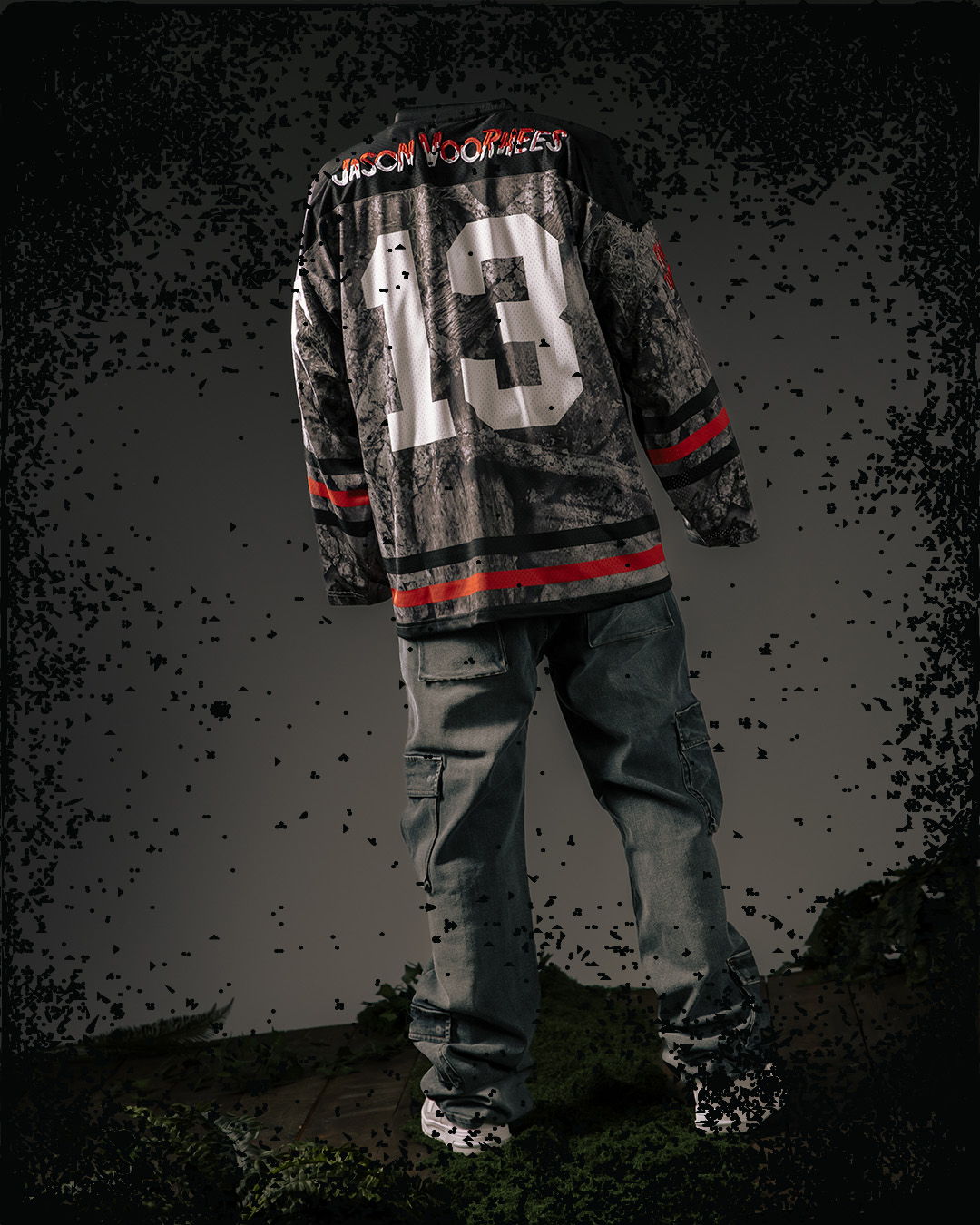 Person wearing a sports jersey with the number 13, standing outdoors.