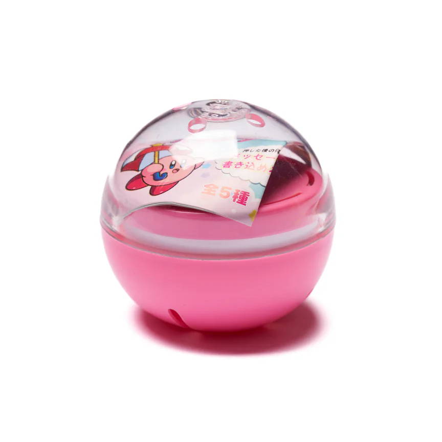 A pink spherical container with a transparent lid and colorful contents inside.
