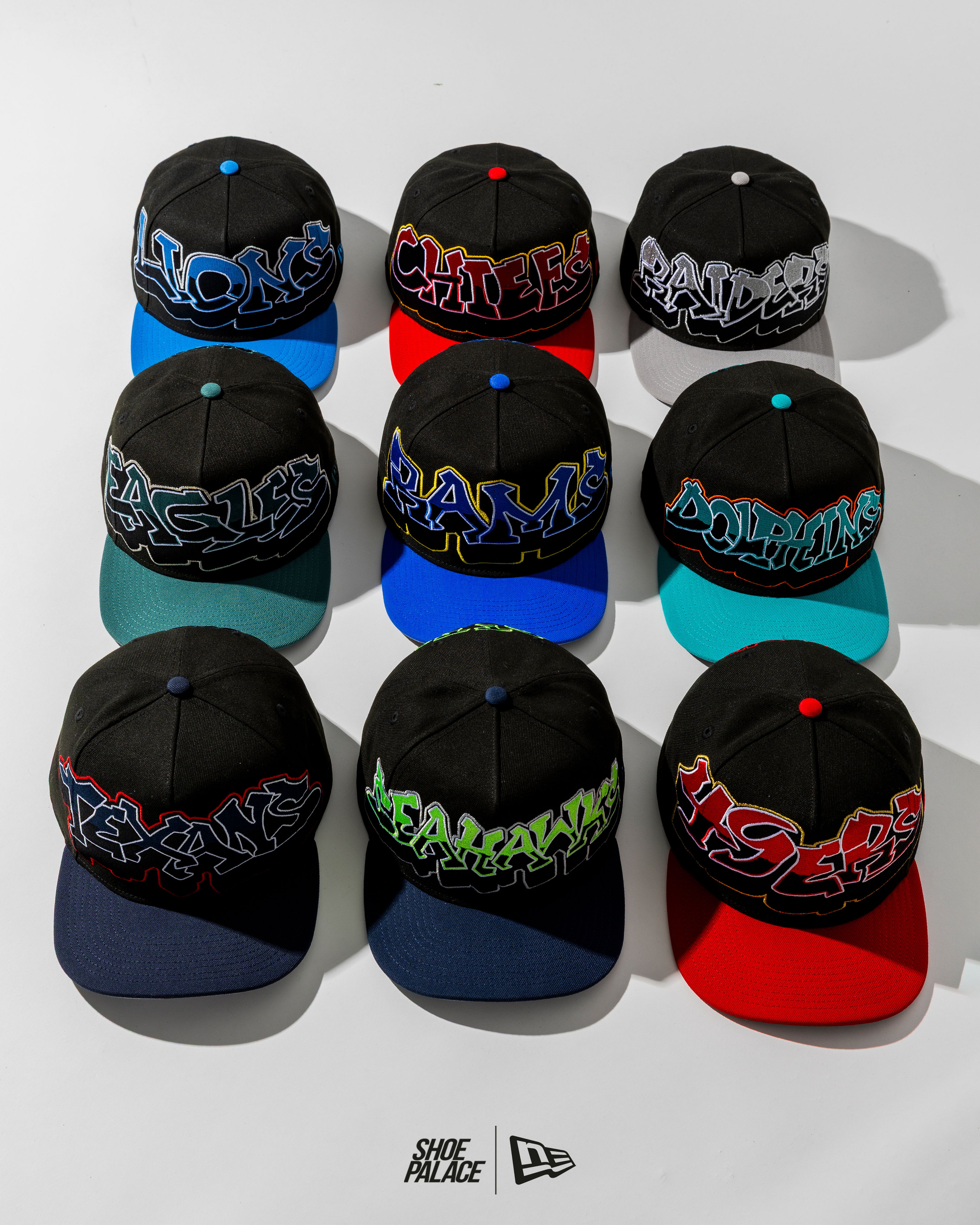 A grid of black caps with colorful graffiti-style text designs.