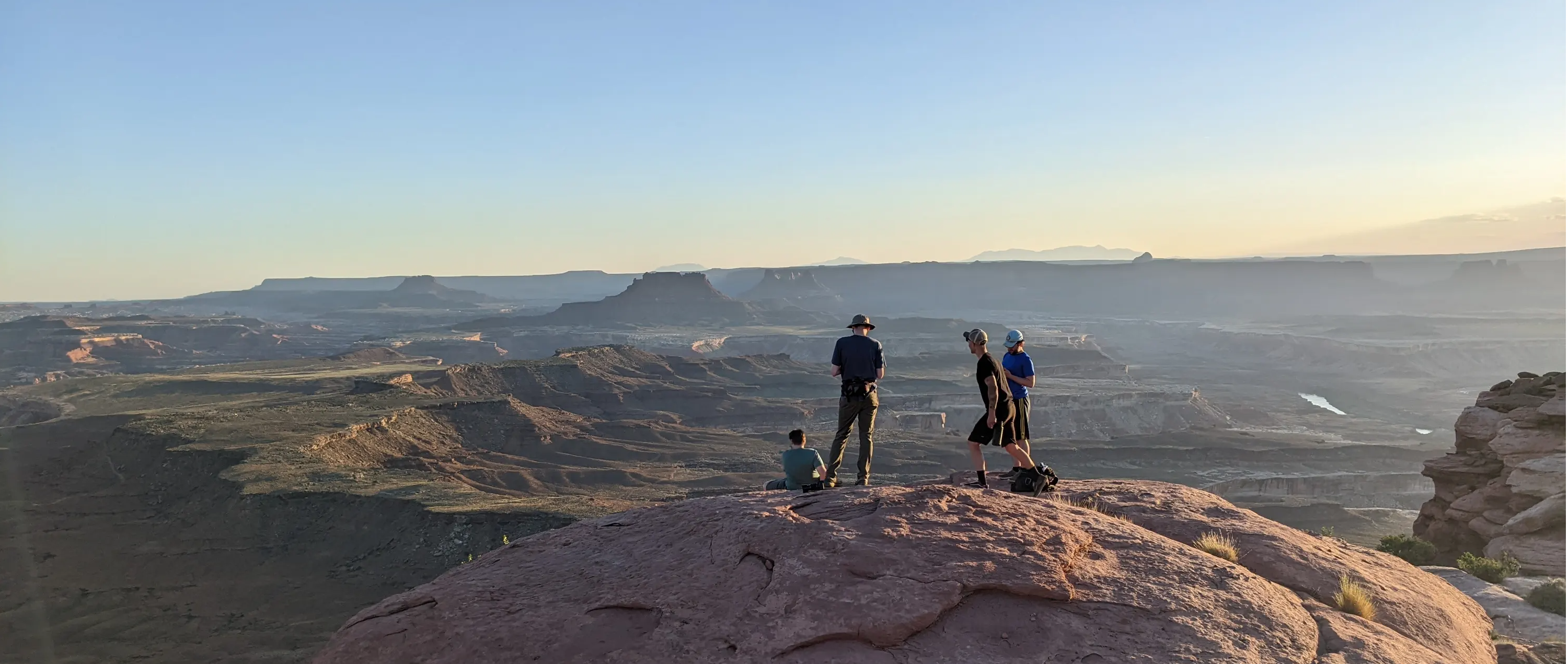 Four guys standing on a rock at Canyonlands National Park