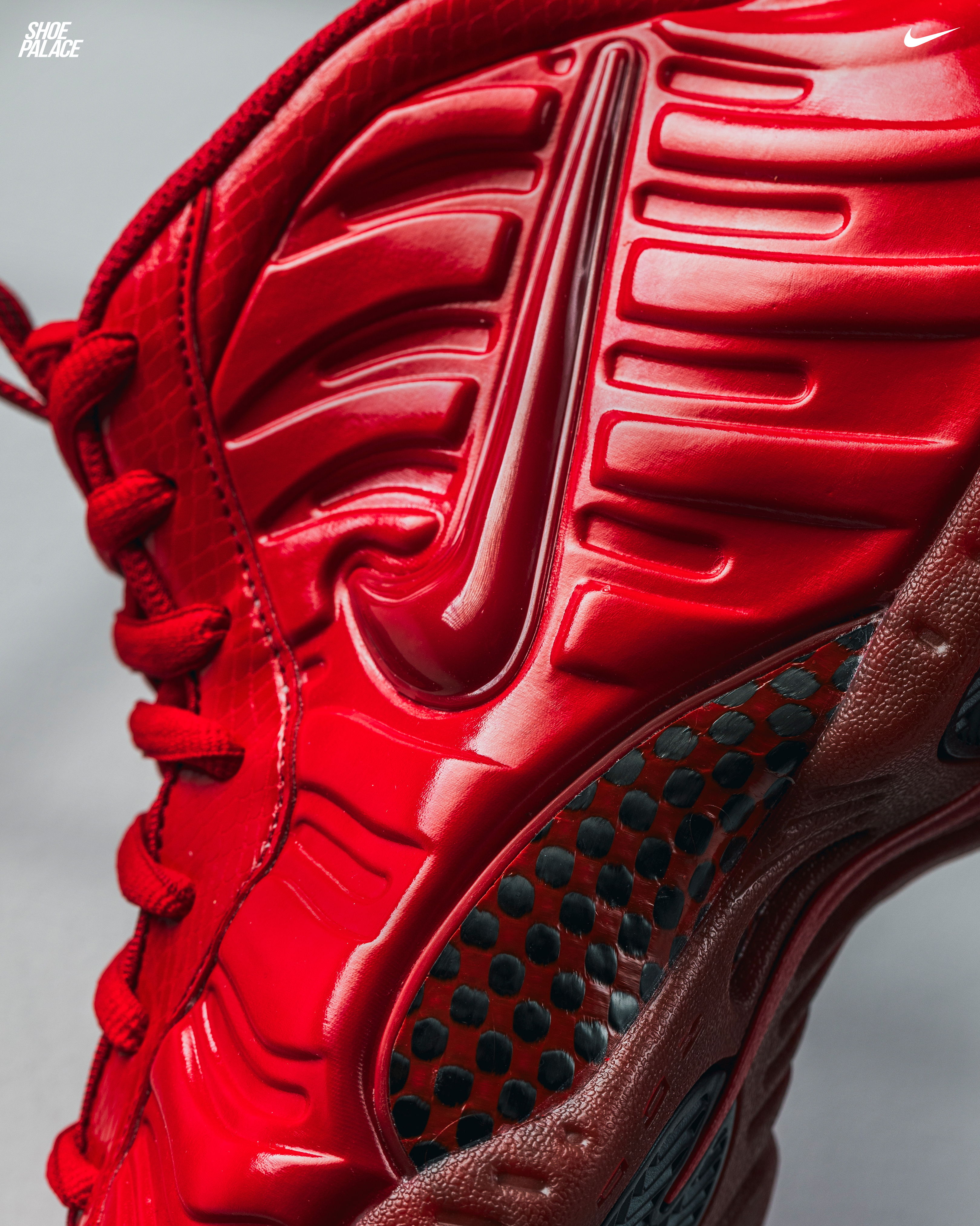 Close-up of a red Nike sneaker with textured design.