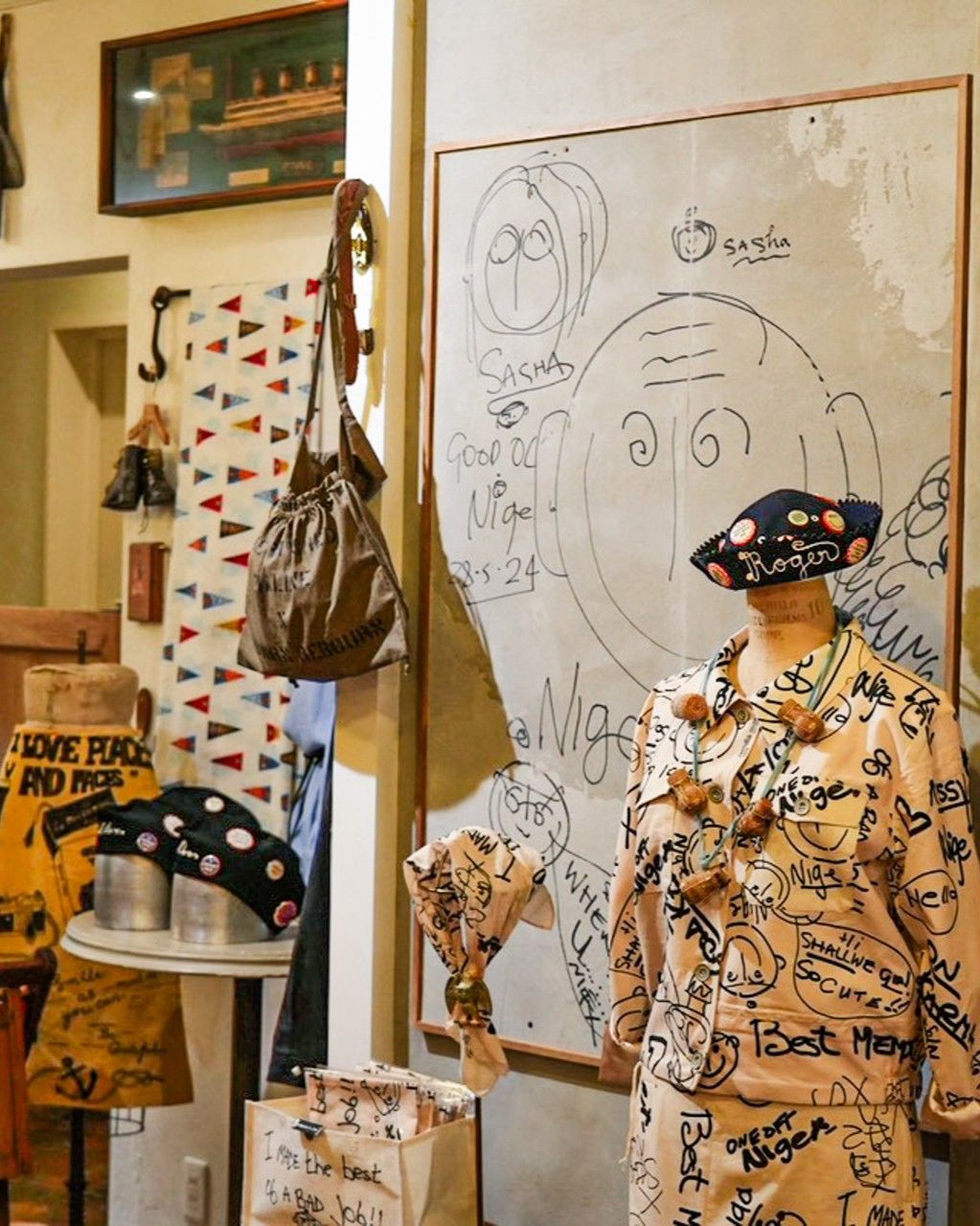 A creative display of clothing and accessories in an artistic shop setting.