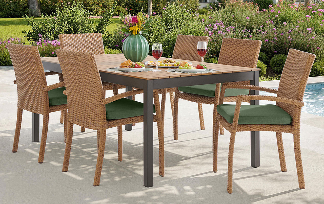 Outdoor dining set with a table, six chairs, and food.