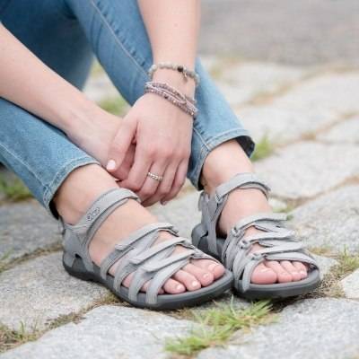 Woman on ground wearing Acadia sport sandals