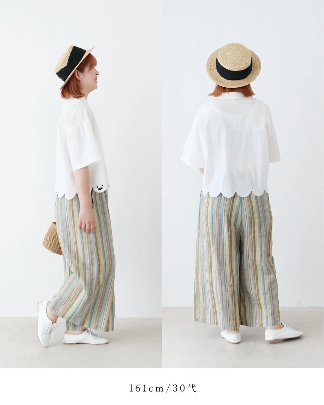 Woman in striped pants and white top, wearing a straw hat.