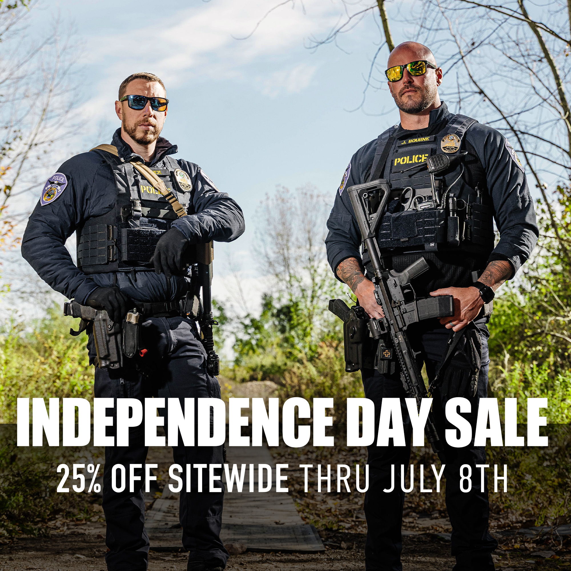 Two armed security personnel promoting an Independence Day sale.