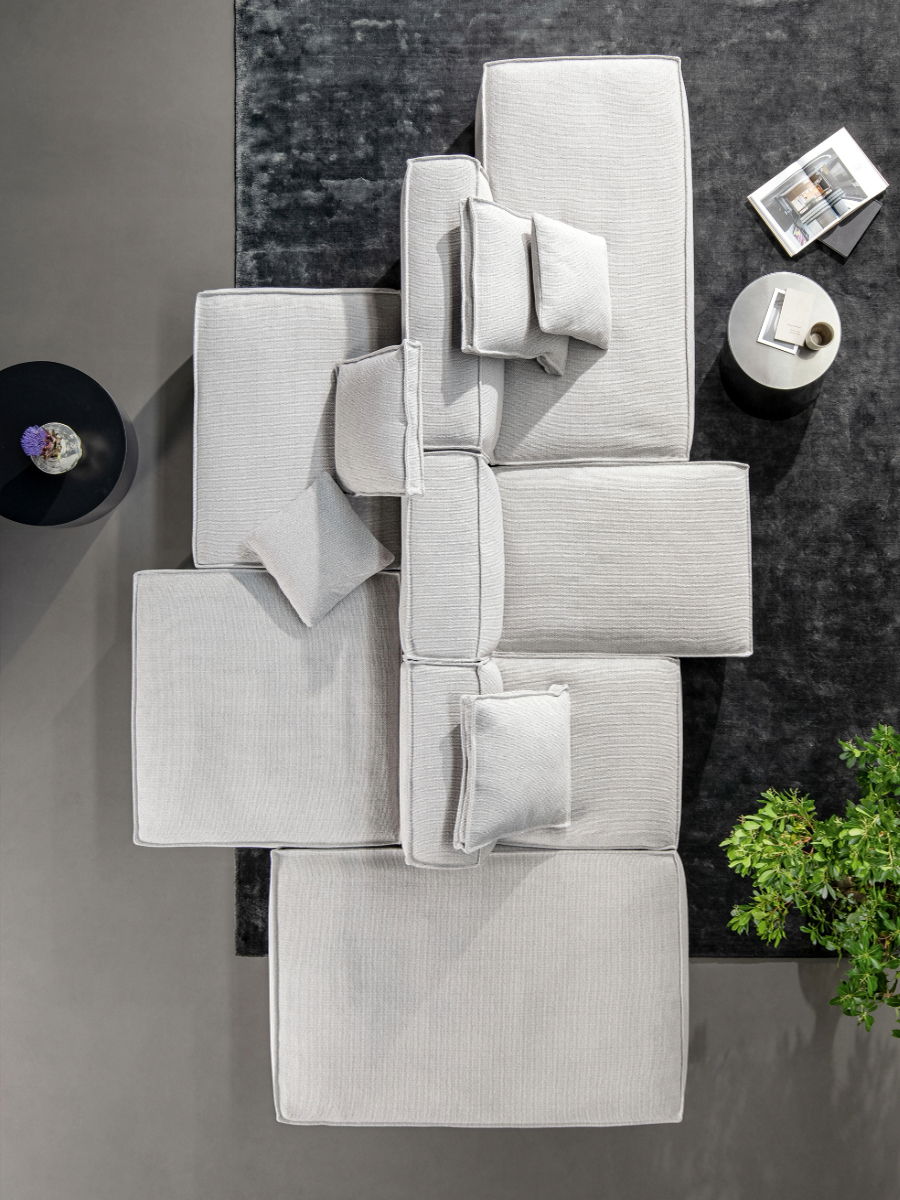 Aerial view of a modern gray Peanut Sofa sectional sofa in grey by Bonaldo and coffee table.