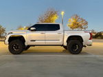Side profile Jay's 2024 Toyota Tundra Platinum white lifted black wheels TRD Off Road decal dusk parking lot Conductor's Special 228H featured customer install gallery photo 1