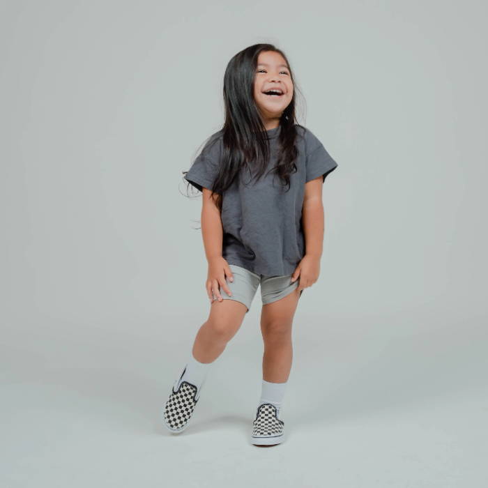 young girl standing and laughing