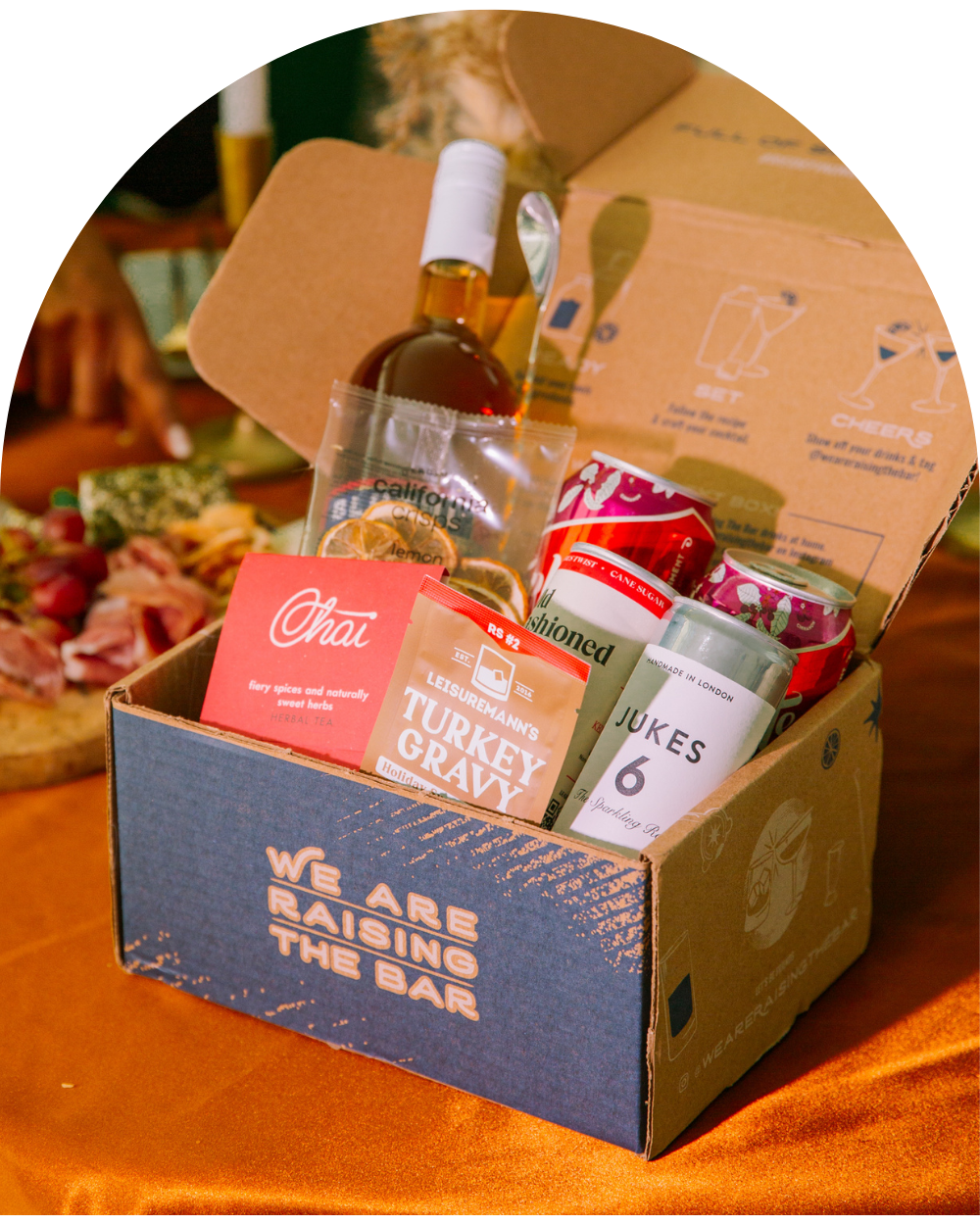 Raising The Bar box full of NA cocktail ingredients on a table